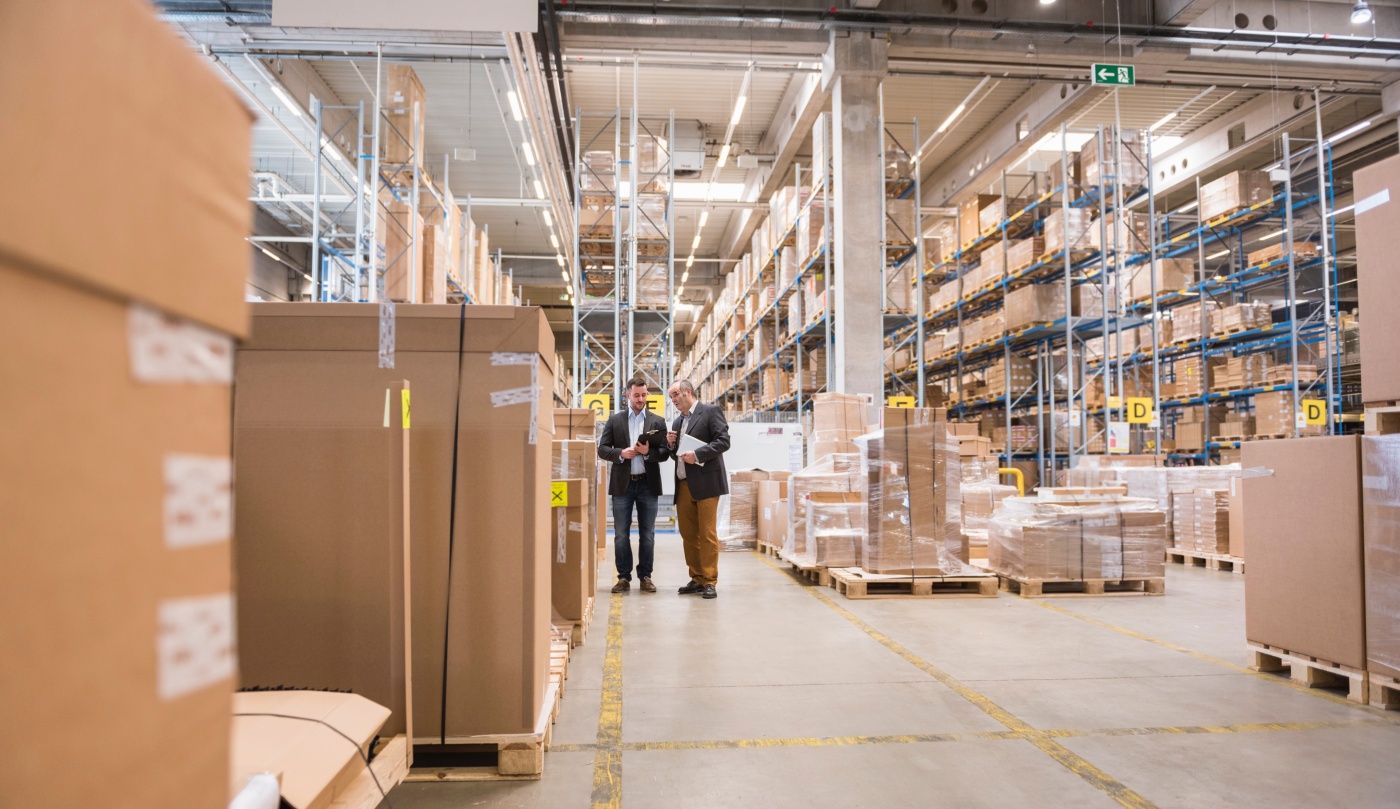 Two men talking in factory warehouse